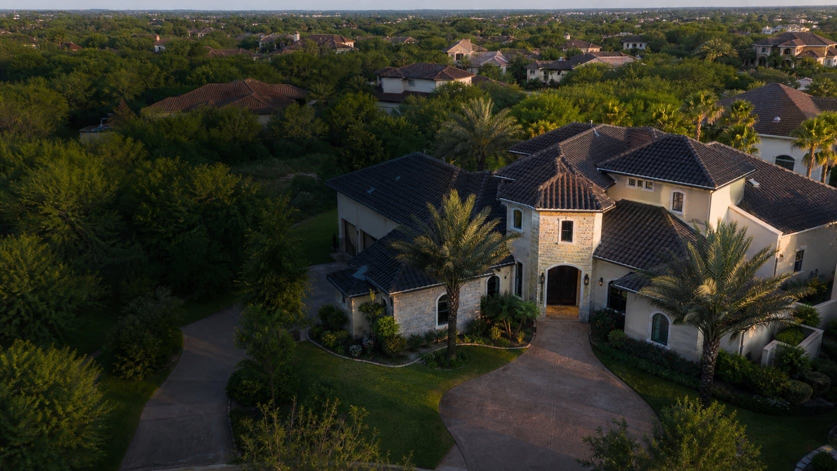 Aerial view of a South Texas home with a tile roof in a landscaped neighborhood